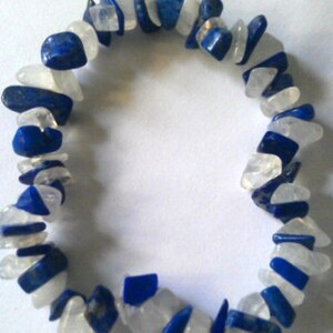 May include: A bracelet made of white and blue gemstone chips. The bracelet is made of natural stones and is a beautiful and unique piece of jewelry.