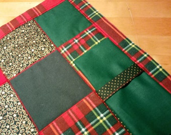 Christmas theme for a pair of double-sided quilted and padded patchwork placemats with coordinating napkin in festive red, green and tartan