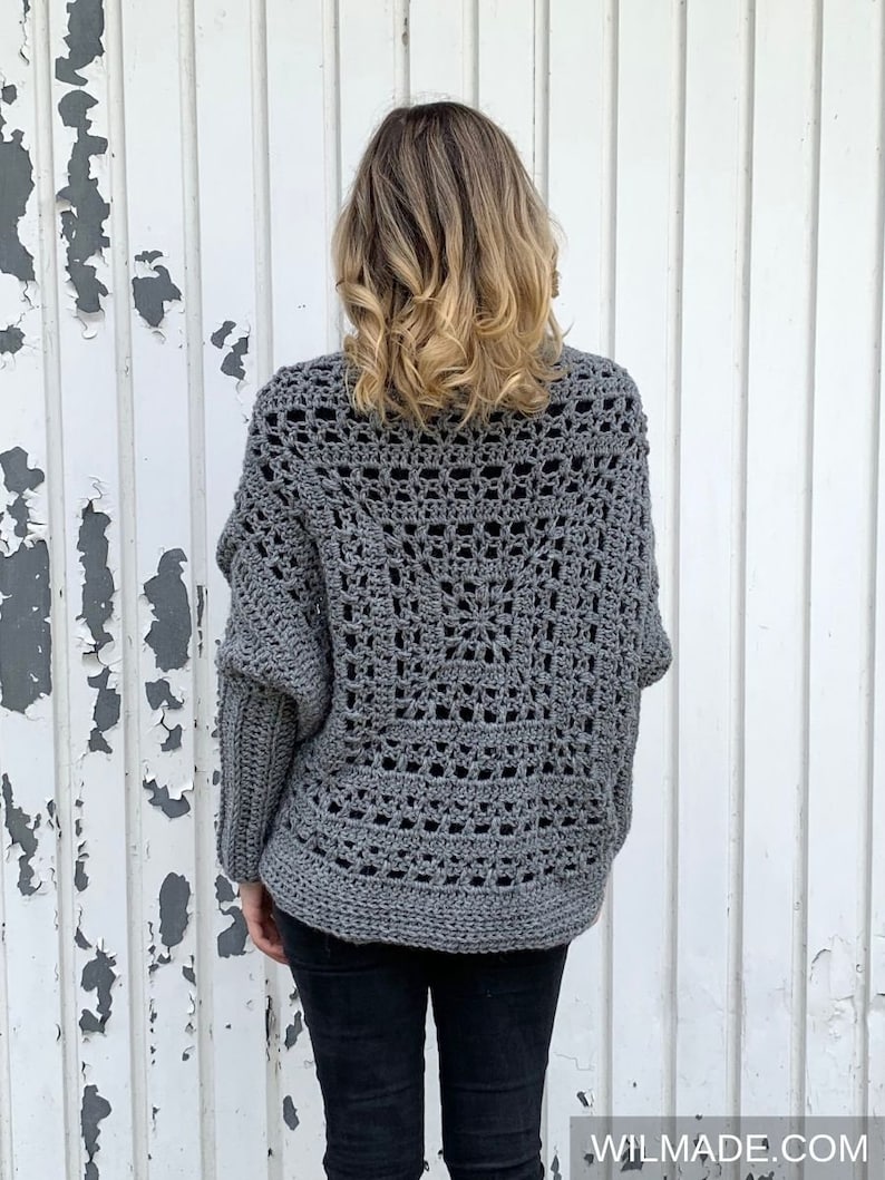 May include: Gray crochet cardigan with a lacy openwork design. The cardigan has a relaxed fit and long sleeves.
