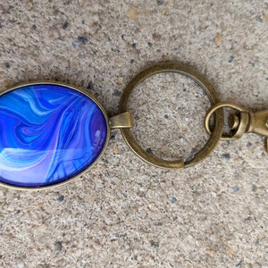 Purple and blue swirled oval paint poured keychain gift