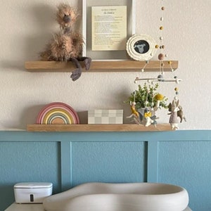 White oak floating shelves in a nursury.