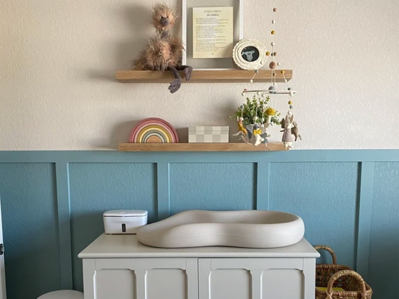 White oak floating shelves in a nursury.
