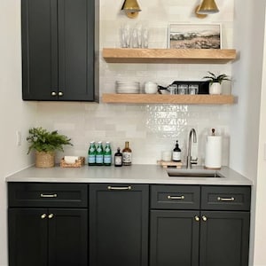 White oak floating shelves above wet bar.