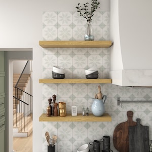 three white oak floating shelves in the kitchen.