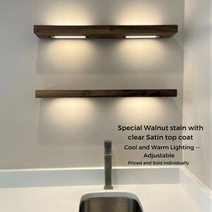 Walnut kitchen floating shelves with battery powered led lighting. bar, liquor, and whiskey floating shelf. solid wood wall shelf down light