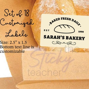 May include: Set of 18 customizable labels, each measuring 2.5 inches by 1.5 inches. The labels feature a vintage-style design with the text "BAKED FRESH DAILY" and "SARAH'S BAKERY" in black lettering on a cream background. The bottom text line is customizable.
