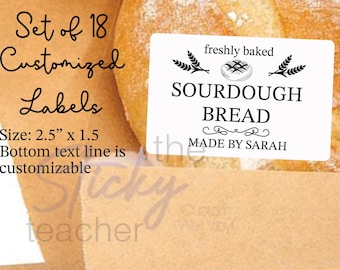 May include: Set of 18 customizable labels for sourdough bread. Each label is 2.5 inches by 1.5 inches and features the text "freshly baked sourdough bread" with a small bread illustration and wheat stalks. The bottom line of the label is customizable.