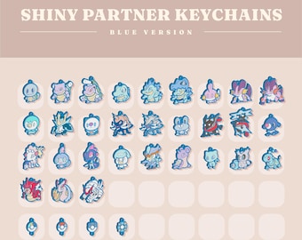 May include: A collection of blue-themed keychains featuring various cartoon characters. The text "SHINY PARTNER KEYCHAINS BLUE VERSION" is displayed at the top. The keychains are arranged in rows and columns on a light brown background.
