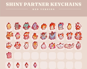 May include: A collection of red-themed Shiny Partner Keychains, featuring various cartoon character designs. The text "SHINY PARTNER KEYCHAINS" and "RED VERSION" are displayed at the top. The keychains are arranged on a light pink background.