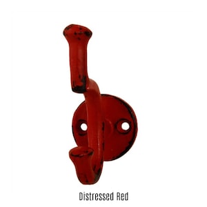 May include: Distressed red metal hook with two hooks. The hook has a round base with two holes.