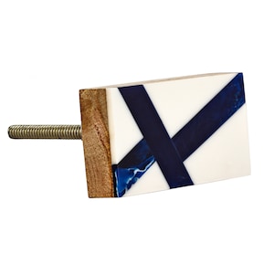 May include: A rectangular cabinet knob with a white base and blue resin inlay. The knob has a wood base and a silver screw.