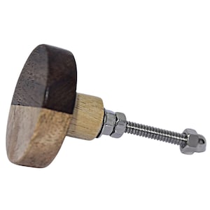May include: A wooden cabinet knob with a dark brown and light wood finish. The knob has a metal screw and nut.