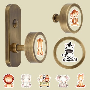 May include: A set of antique brass-toned hardware including a rectangular wall plate with a round knob, a circular knob, and a circular ring pull. Each piece features a watercolor-style illustration of a jungle animal, including a monkey, tiger, and zebra.