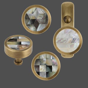 May include: Set of four round brass cabinet knobs with a mother-of-pearl inlay. The knobs feature different geometric patterns.