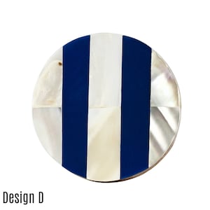 May include: Round coaster with a blue and white striped design. The coaster is made of mother of pearl and has a glossy finish.