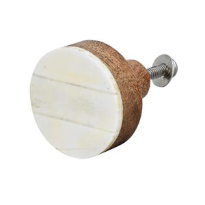 May include: A round wooden cabinet knob with a white, segmented face. The knob has a dark brown wooden body and a metal screw for attachment. The white face is made of rectangular pieces. The knob is designed for furniture.