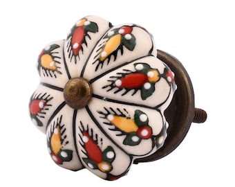 May include: White ceramic cabinet knob with a floral design in red, yellow, and green. The knob has a brass screw and a brass base.