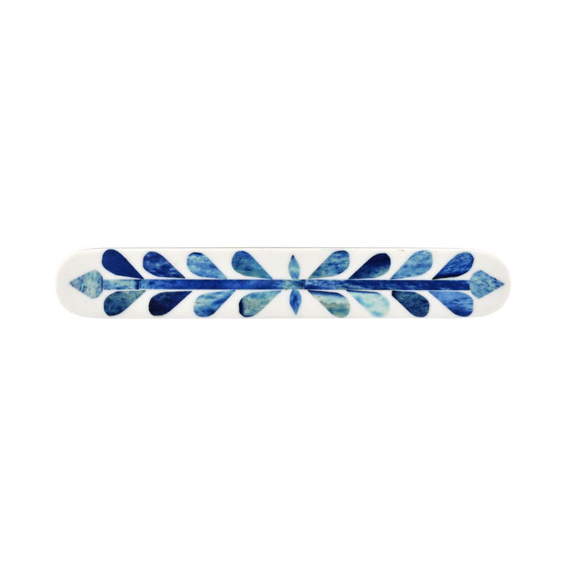 May include: A long, rectangular decorative bar featuring a white base with a central horizontal line and symmetrical, leaf-shaped patterns in various shades of blue, ranging from light sky blue to deep navy, arranged along the entire length.