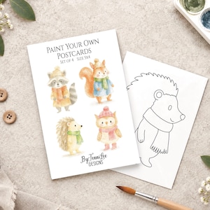 May include: A set of four paint your own postcards featuring watercolor illustrations of a raccoon, squirrel, hedgehog, and owl wearing winter accessories. The text reads Paint Your Own Postcards Set of 4 Size 5x4 and By Jenni Lee Designs.