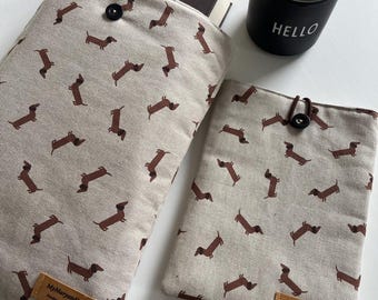May include: Two beige book covers with a repeating brown dachshund pattern. One cover holds a book titled "Harry Potter and the Order of the Phoenix." A black mug with "HELLO" in white is next to the covers. The covers have a brown leather tag that says "MyMaryandMe."
