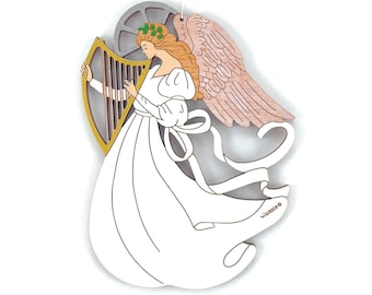 May include: A wooden angel ornament playing a harp with a pink and brown wing, a white dress, and a green wreath. The ornament is signed "Wallace".