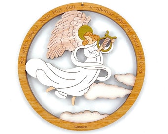 May include: A wooden Christmas bauble depicting a white angel with gold wings playing a harp. The angel is surrounded by clouds and the text "For unto you is born this day a saviour which is Christ the Lord" is inscribed around the edge.