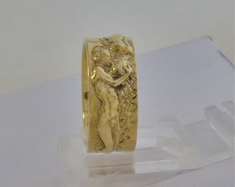 The Kiss a wedding band. Sculpted figures forever in a kiss.