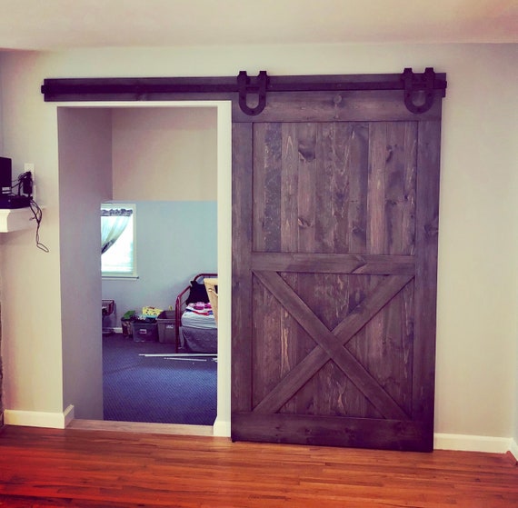 We Love This Gorgeous Stained Z Barn Door Paired With The Industrial Stag System The Matching Header Really Brin Rustic Barn Door Barn Door Barn Door Bookcase