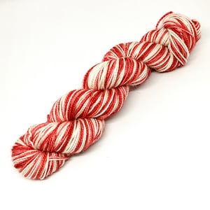 May include: Red and white striped yarn skein.