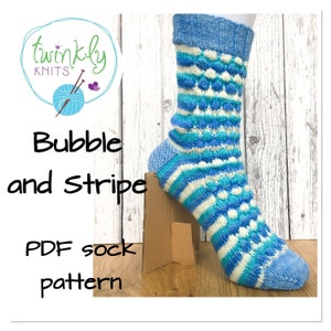 May include: A PDF knitting pattern for a blue, white, and teal striped sock with a bubble stitch pattern. The pattern is titled "Bubble and Stripe" and is from "Twinkly Knits".
