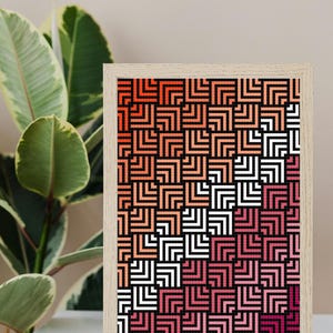 May include: A framed geometric print with a black background and a pattern of overlapping squares in shades of red, orange, and white.