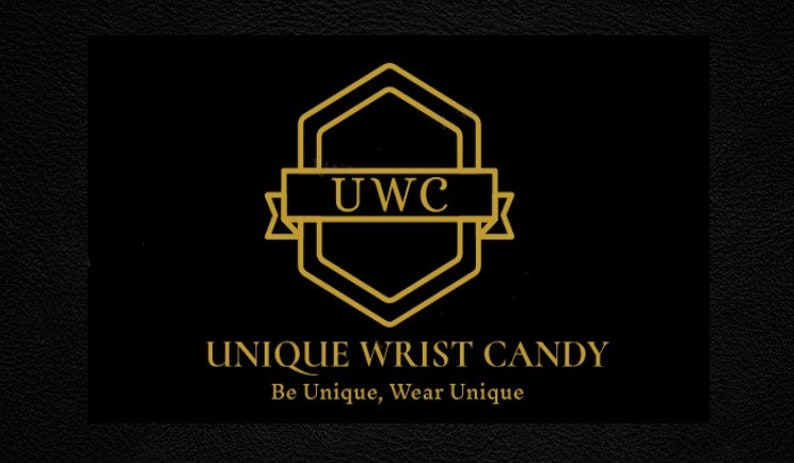 May include: Gold logo with the text "UWC" inside a hexagon shape. The text "UNIQUE WRIST CANDY" is below the logo, and the tagline "Be Unique, Wear Unique" is below the text.