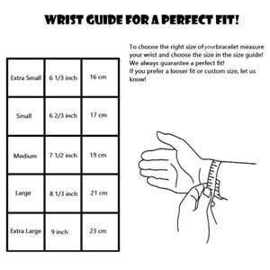 May include: A black and white wrist size guide for bracelets. The guide includes measurements in inches and centimetres for extra small (16 cm) to extra large (23 cm). The text reads "WRIST GUIDE FOR A PERFECT FIT!"