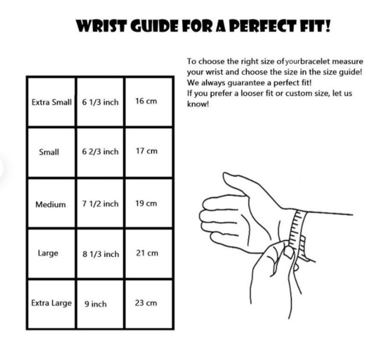 May include: A black and white wrist size guide for bracelets. The guide includes measurements in inches and centimetres for extra small (16 cm) to extra large (23 cm). The text reads "WRIST GUIDE FOR A PERFECT FIT!"