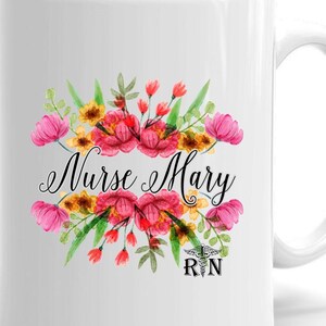 May include: White ceramic mug with a floral design and the text "Nurse Mary RN". The flowers are pink, red, yellow, and green.