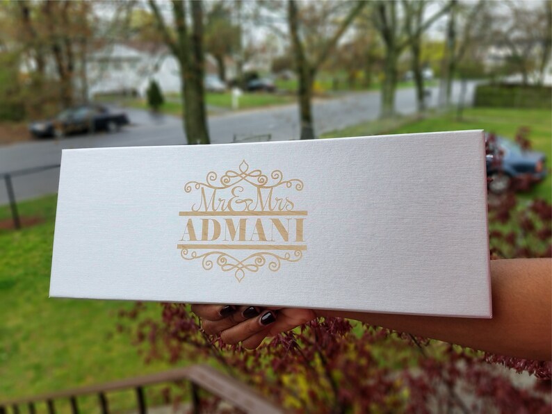 May include: White gift box with a gold embossed design that says "Mr. & Mrs. ADMANI".