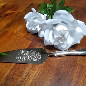 May include: Silver cake server with the inscription "Mr. & Mrs. Hopping, July 13, 2019" engraved on the blade.