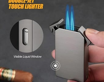May include: A silver double-jet touch lighter with a visible liquid window. The lighter has a double flame and is in a hand.