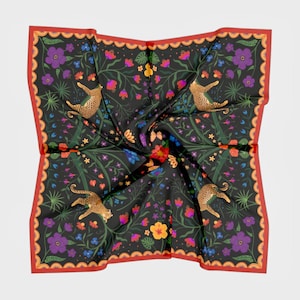 May include: A square scarf featuring a black background with a repeating pattern of leopards, purple and yellow flowers, and green foliage. The scarf is framed by a decorative orange border with a scalloped edge and small circular accents.