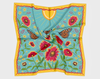 May include: A blue and yellow square scarf with a floral pattern. The pattern features red flowers, green leaves, and orange butterflies. The scarf has a yellow border.