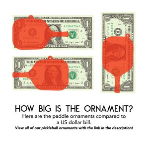 May include: A red pickleball paddle ornament is shown next to a US dollar bill. The ornament is the same size as the dollar bill. The text "HOW BIG IS THE ORNAMENT?" is shown above the image. The text below the image reads "Here are the paddle ornaments compared to a US dollar bill. View all of our pickleball ornaments with the link in the description!"