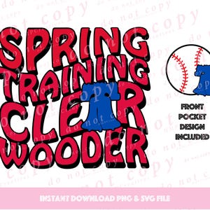 May include: Red and blue graphic design with the text "Spring Training Clear Water" in a bold, cartoon font. A baseball with red stitching and a blue Liberty Bell are included in the design.