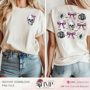 May include: A white t-shirt with a skull wearing a purple bow on the front and a skull with purple bows, bats, pumpkins, and spiders on the back.