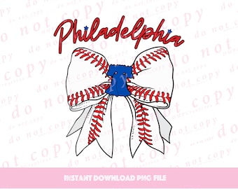May include: A white baseball-themed bow with red stitching and a blue star. The word "Philadelphia" is written in red above the bow.