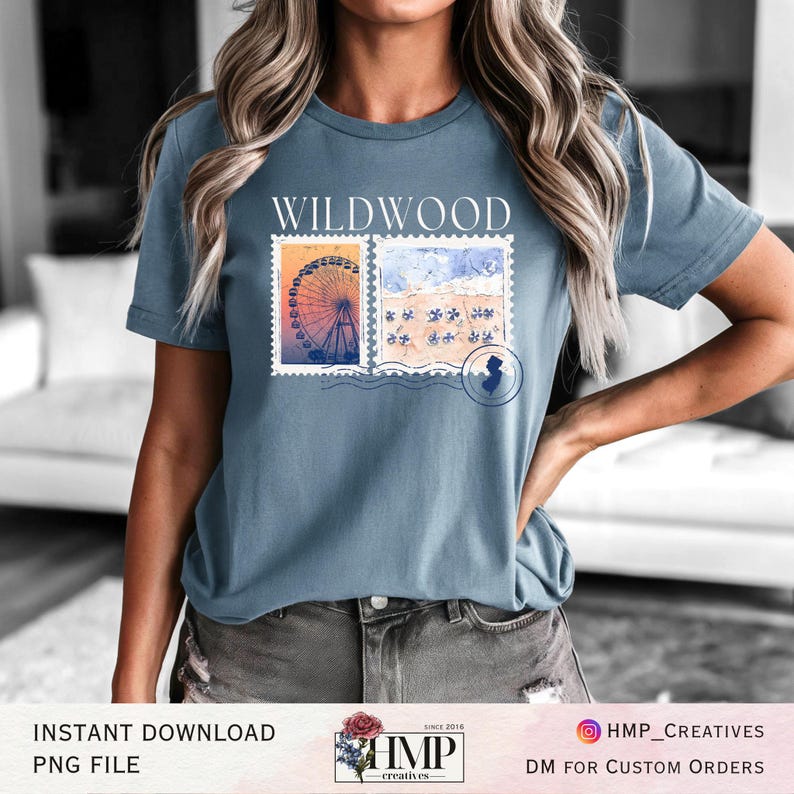 May include: A blue t-shirt with the text "WILDWOOD" printed on the front. The design features two vintage postage stamps with images of a Ferris wheel and a beach scene. The text "HMP creatives" is printed on the bottom right corner of the image.