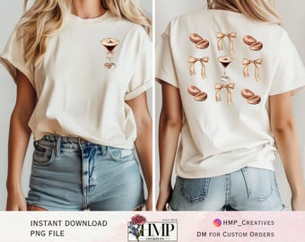May include: A white t-shirt with a graphic of a cocktail glass and donuts with bows on the front and back. The text "HMP_CREATIVES" and "DM FOR CUSTOM ORDERS" is on the bottom of the image.