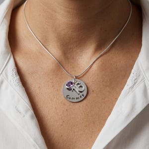 A personalised name necklace being worn