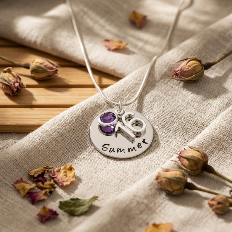 A personalised 16th birthday necklace gift laid on a linen cloth
