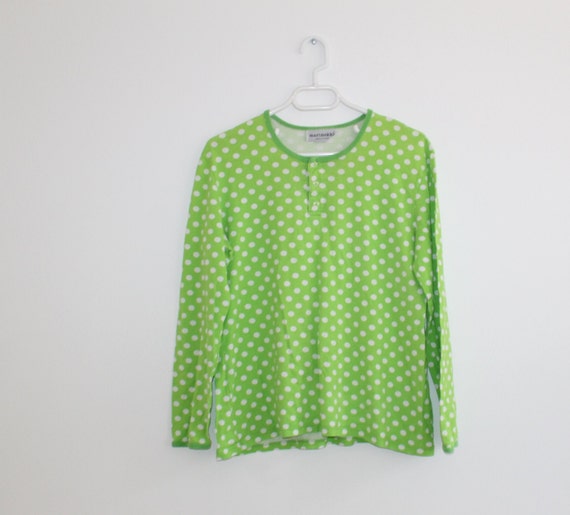 green blouse with white polka dots