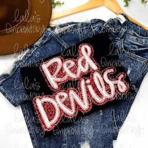 May include: A black t-shirt with a red and white embroidered patch that says "Red Devils".